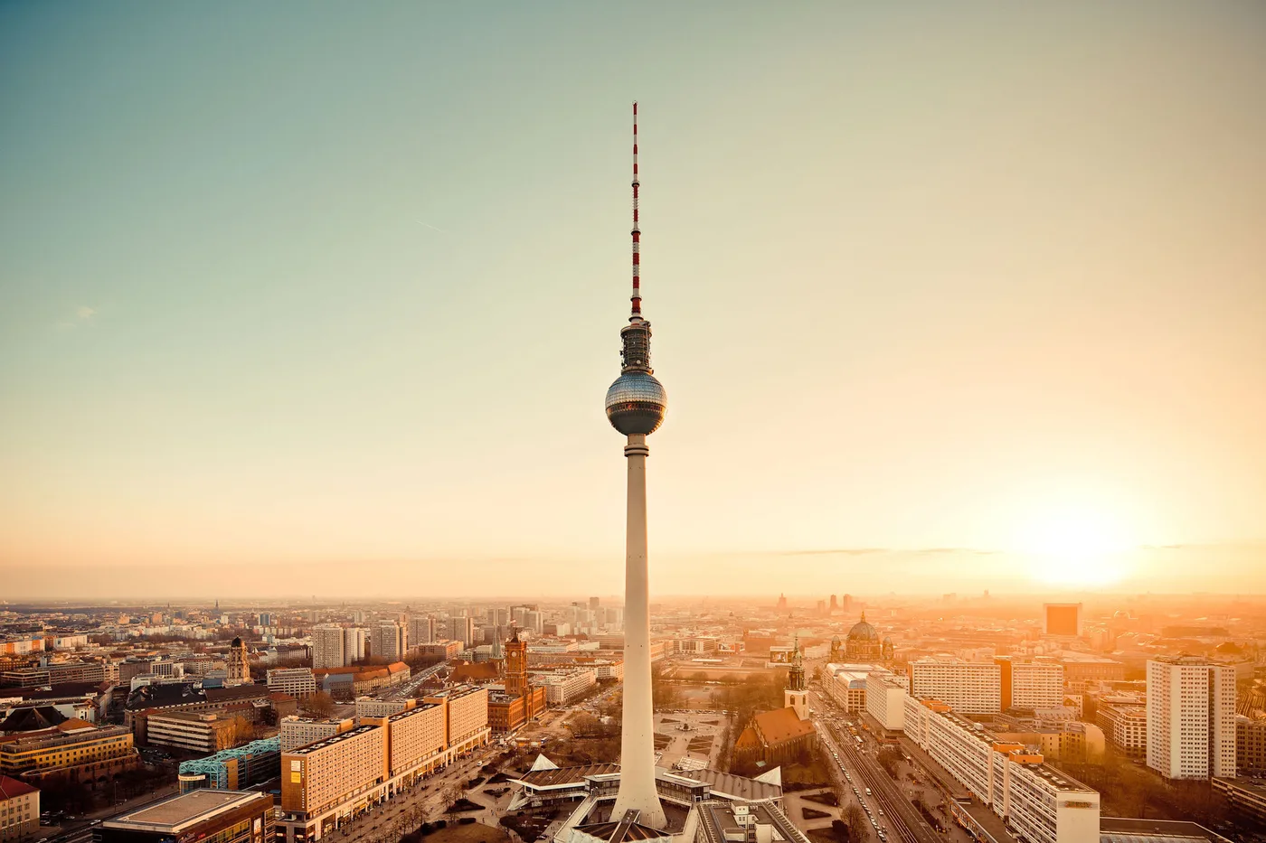 Berlin at sunset from above, the television tower at Alexanderplatz standing over the city